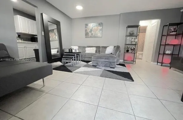 a living room with furniture a piano and a flat screen tv