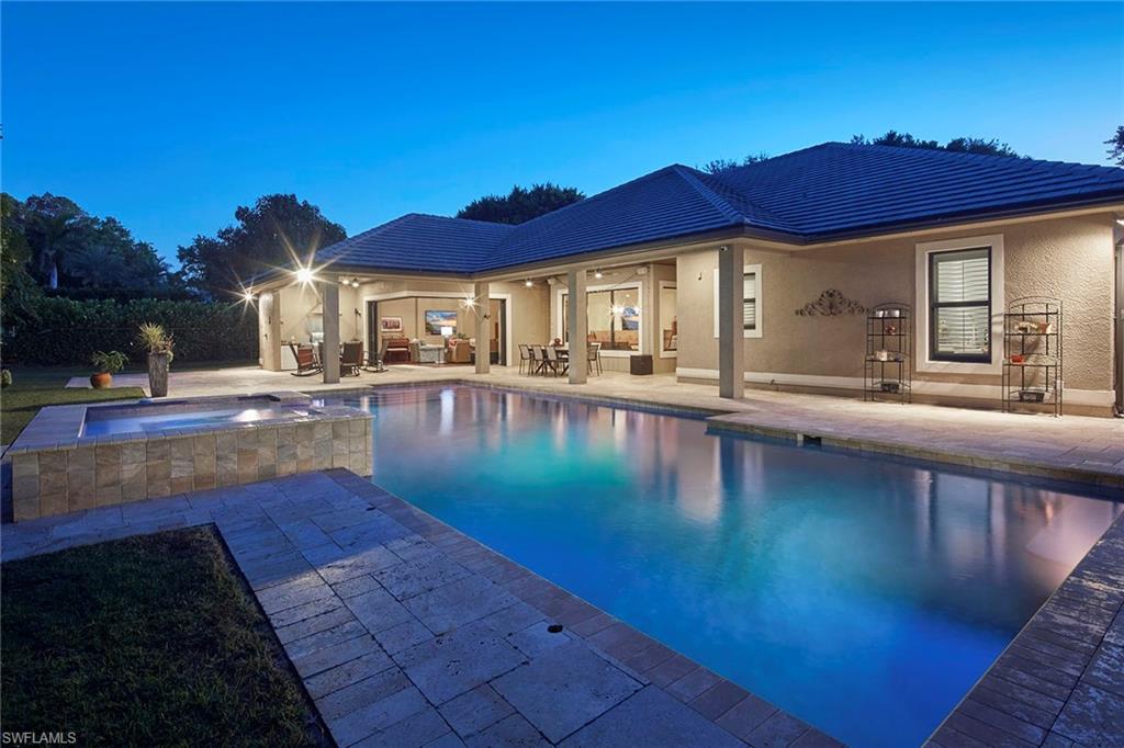 1900 Tiller Terrace Naples, FL 34102 - Photo 1 of 46 a swimming pool with outdoor seating