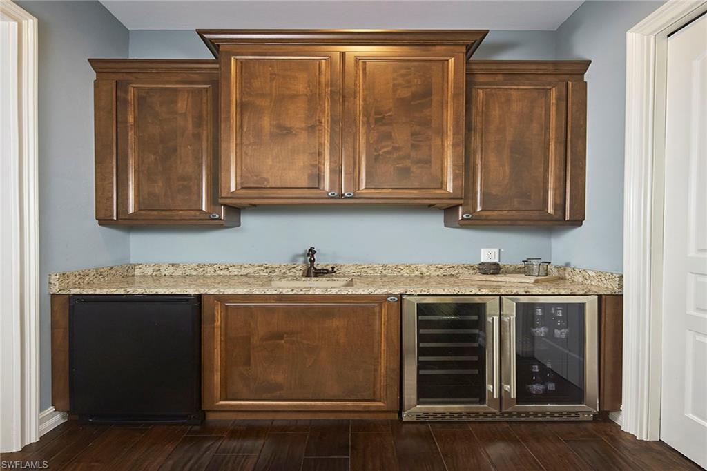 1900 Tiller Terrace Naples, FL 34102 - Photo 17 of 46 a kitchen with stainless steel appliances granite countertop a stove and a microwave