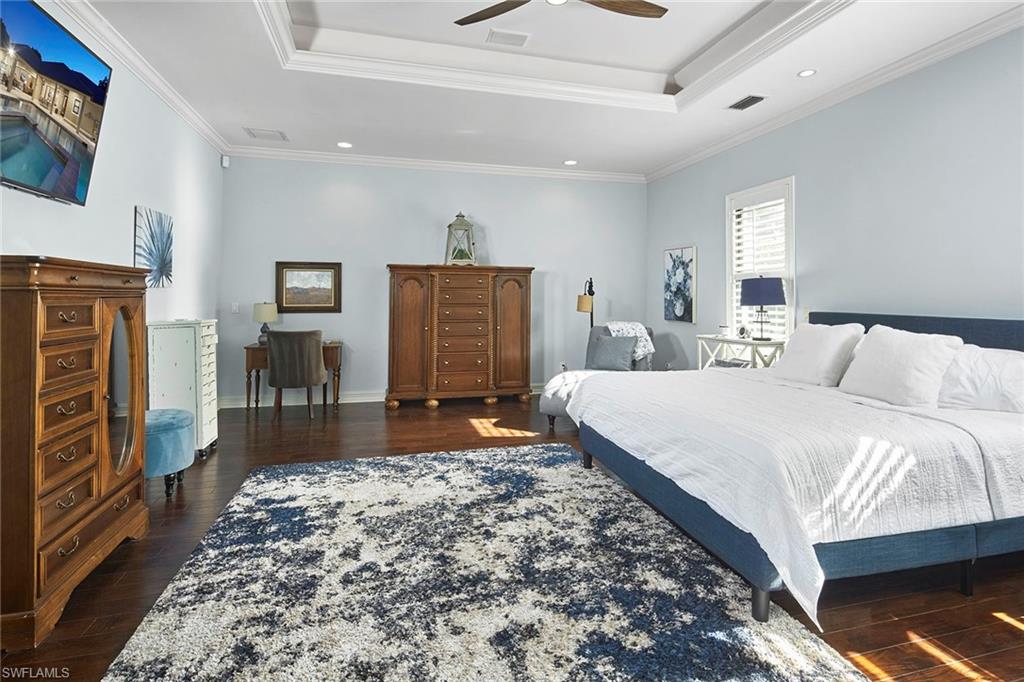 1900 Tiller Terrace Naples, FL 34102 - Photo 20 of 46 a spacious bedroom with a bed and a couch