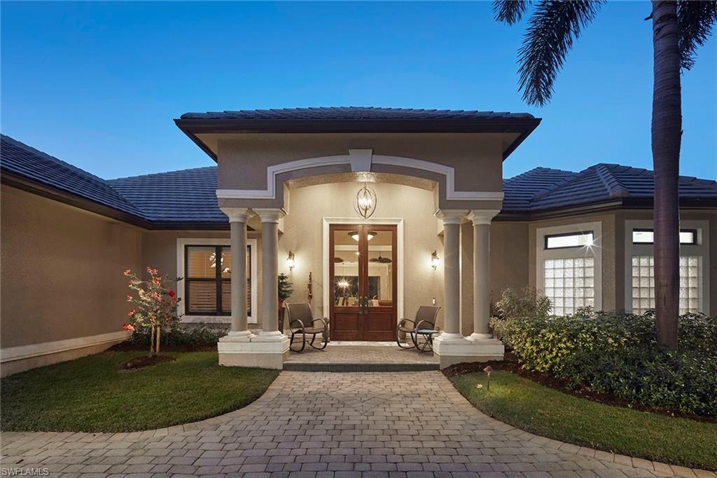 1900 Tiller Terrace Naples, FL 34102 - Photo 2 of 46 a view of a house with brick walls and a yard with plants