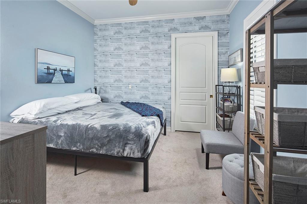 1900 Tiller Terrace Naples, FL 34102 - Photo 25 of 46 a bedroom with a bed and a table