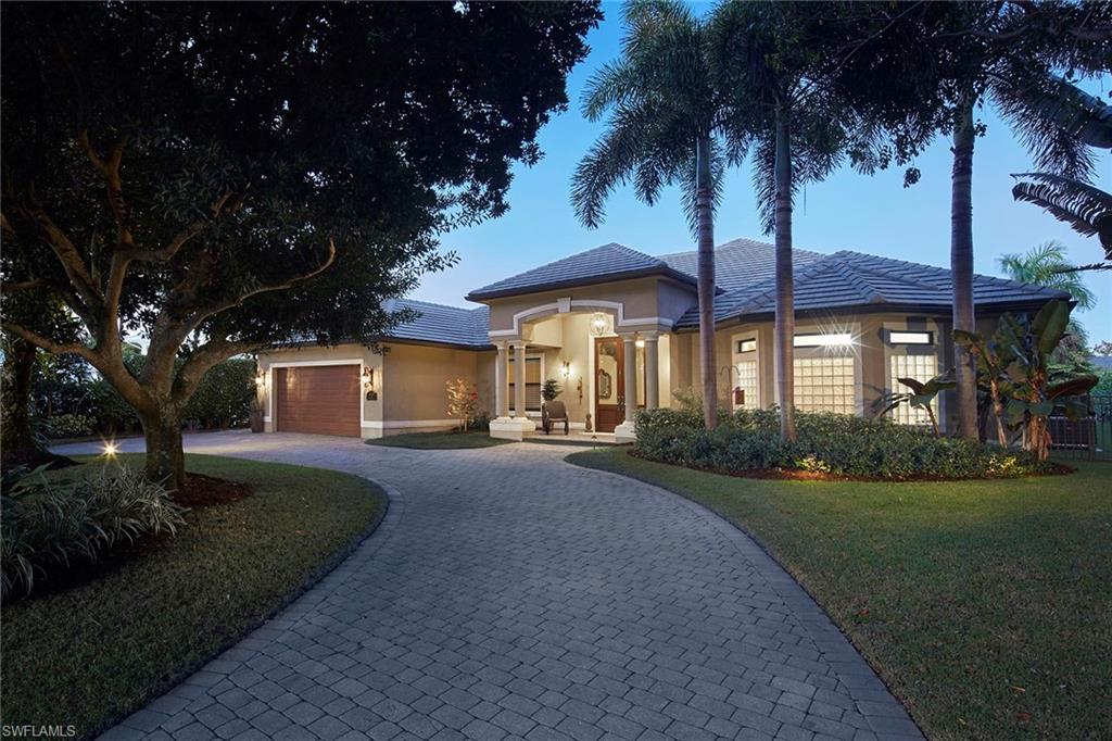 1900 Tiller Terrace Naples, FL 34102 - Photo 3 of 46 a front view of a house with a garden and tree