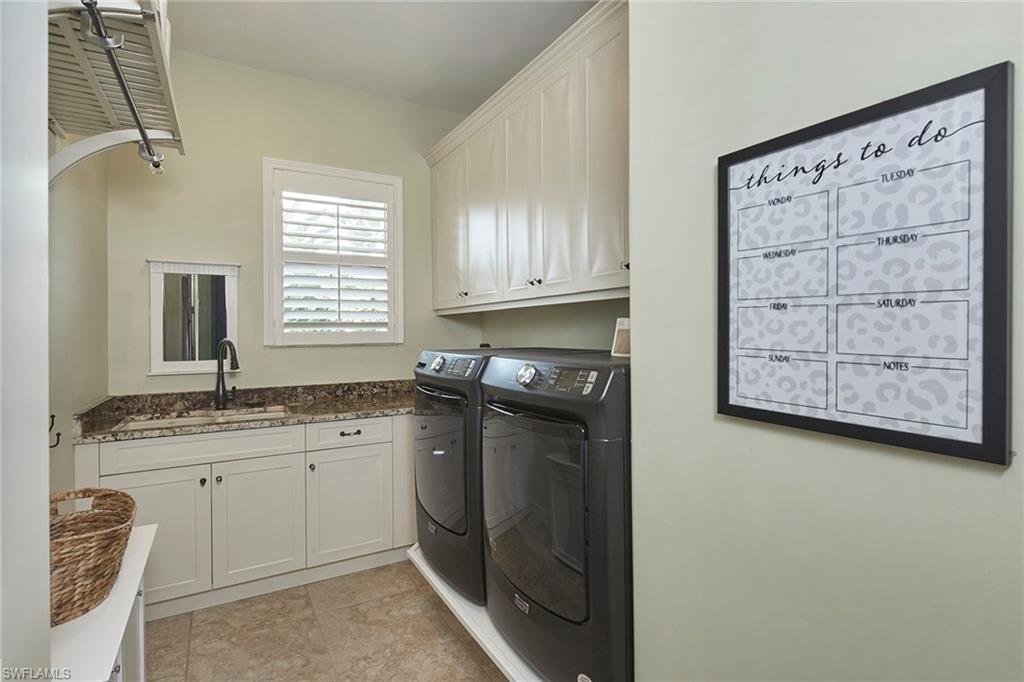 1900 Tiller Terrace Naples, FL 34102 - Photo 37 of 46 a kitchen with stainless steel appliances granite countertop a sink stove and cabinets