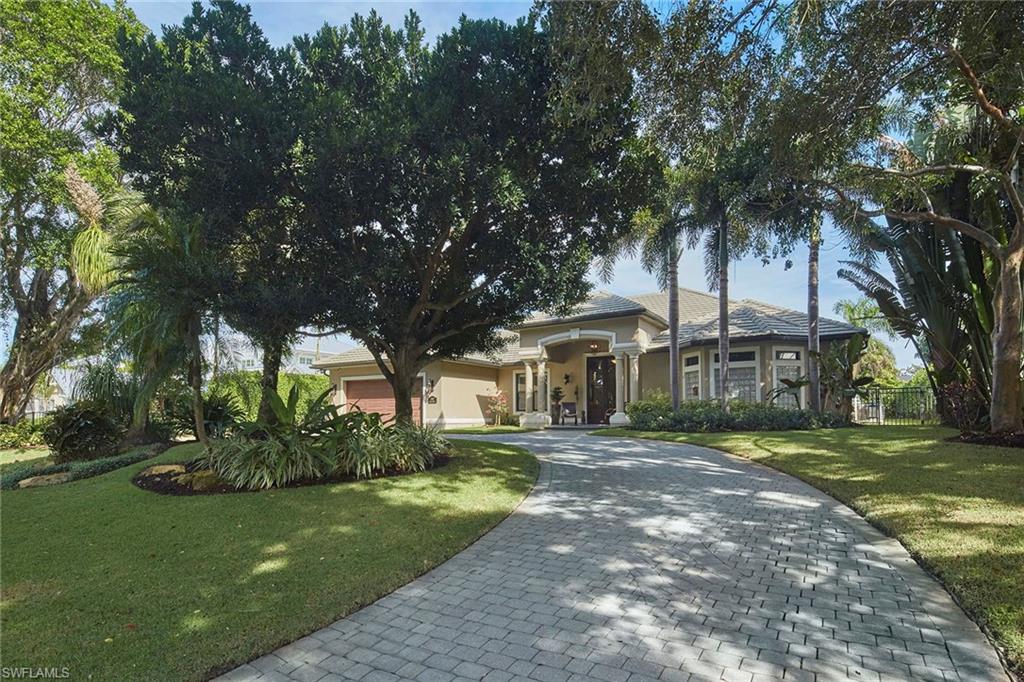 1900 Tiller Terrace Naples, FL 34102 - Photo 38 of 46 a front view of a house with a garden