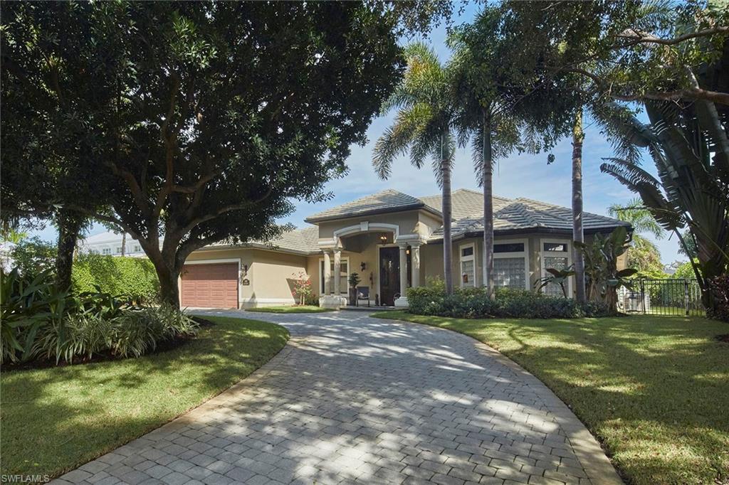 1900 Tiller Terrace Naples, FL 34102 - Photo 39 of 46 a front view of a house with garden