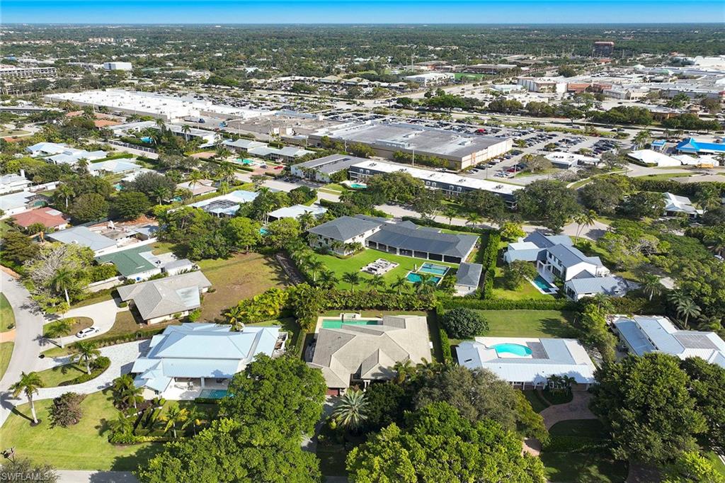 1900 Tiller Terrace Naples, FL 34102 - Photo 43 of 46 an aerial view of residential building with parking and yard