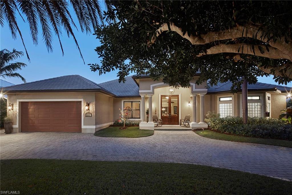 1900 Tiller Terrace Naples, FL 34102 - Photo 46 of 46 a front view of a house with garden