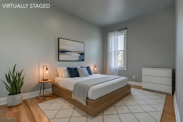 a bedroom with a bed and a potted plant