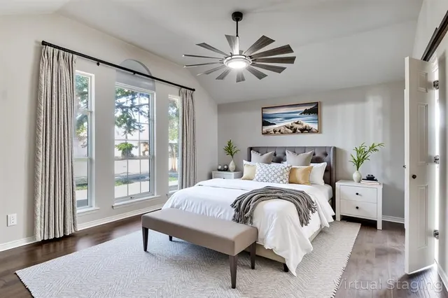 a bedroom with a bed and a large window