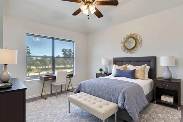 a bedroom with a large bed and a window