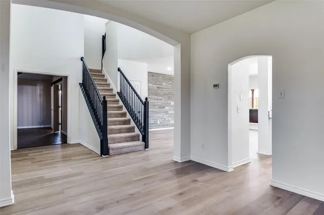 a view of entryway with wooden floor and stairs
