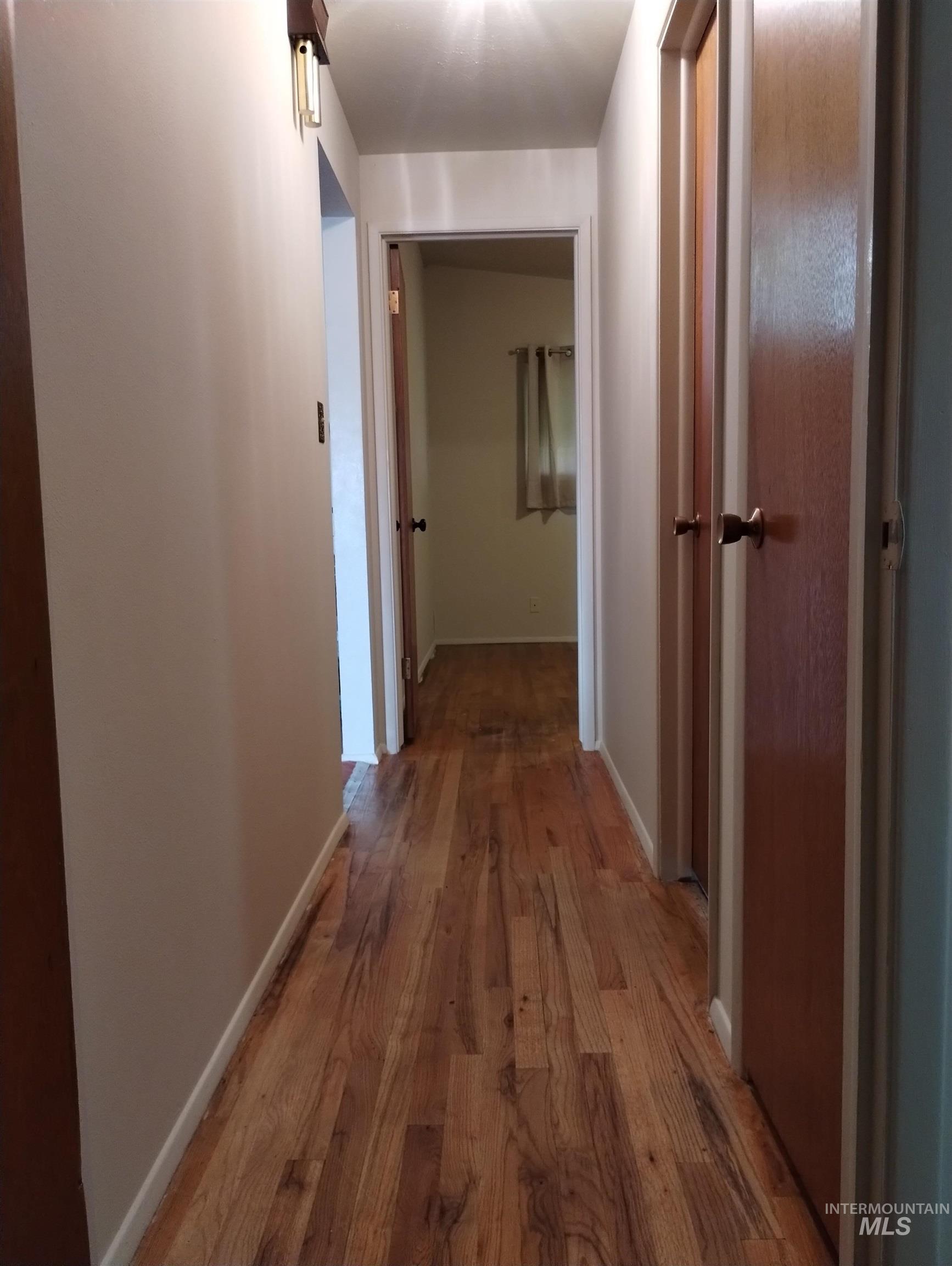 1298 East 2nd Street Weiser, ID 83672 - Photo 15 of 34 Hall with dark wood finished floors and baseboards
