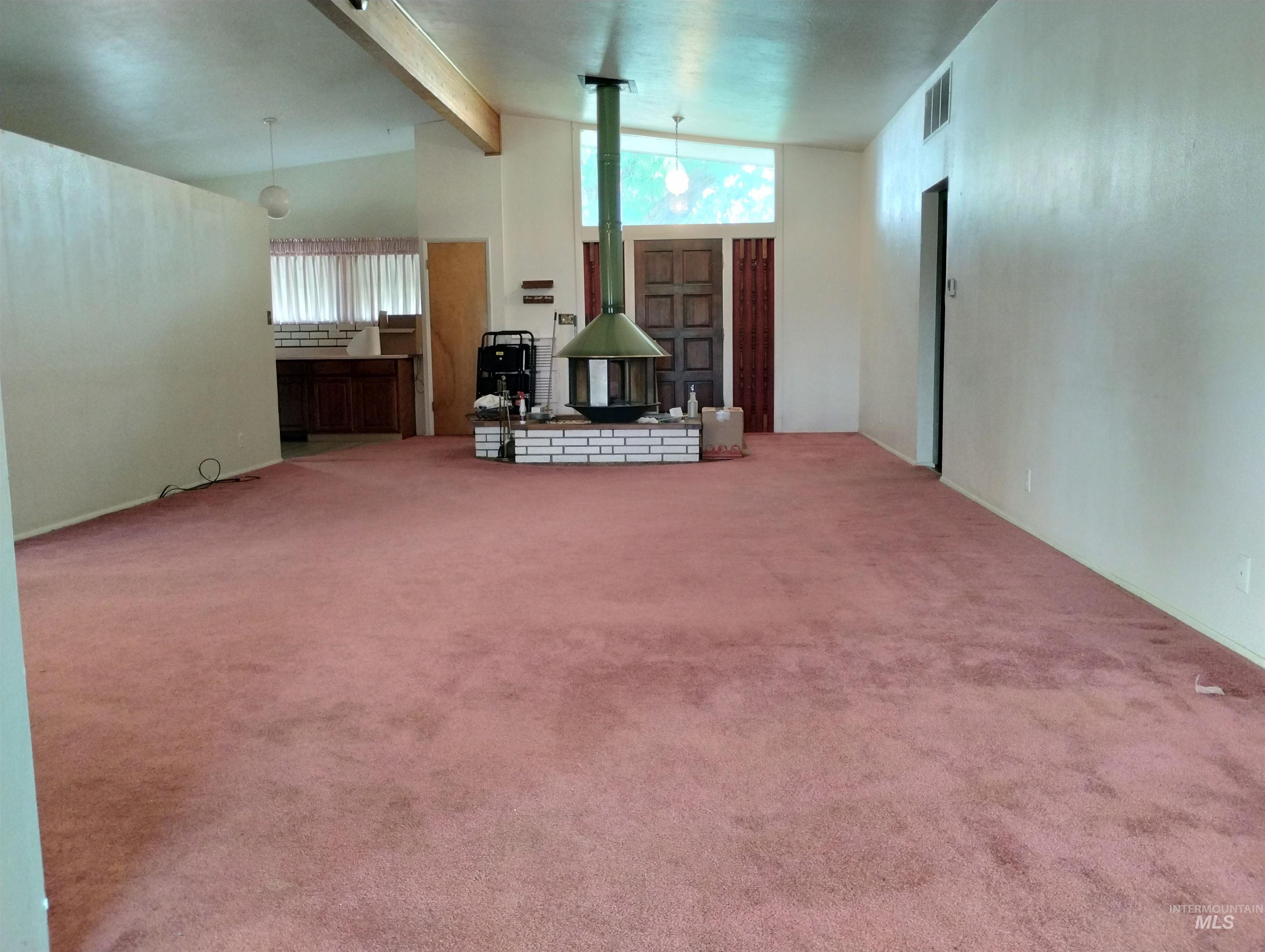 1298 East 2nd Street Weiser, ID 83672 - Photo 3 of 34 Living room with beam ceiling, carpet floors, and high vaulted ceiling