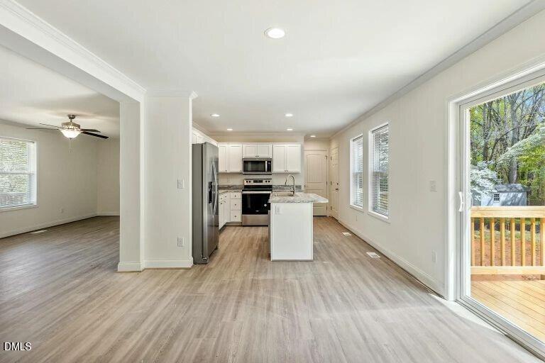 7120 Guess Road Hillsborough, NC 27278 - Photo 15 of 27 a view of kitchen with refrigerator stove and wooden floor