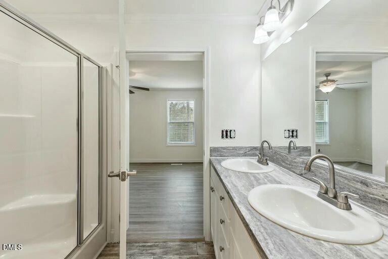 7120 Guess Road Hillsborough, NC 27278 - Photo 22 of 27 a bathroom with a granite countertop sink a mirror and a bathtub