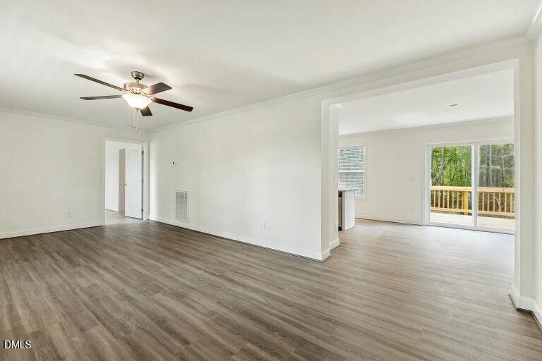7120 Guess Road Hillsborough, NC 27278 - Photo 7 of 27 a view of a room with wooden floor and ceiling fan