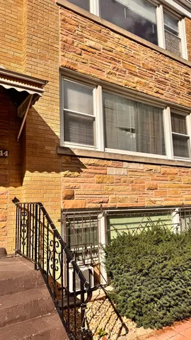 a view of a balcony with wooden floor and fence