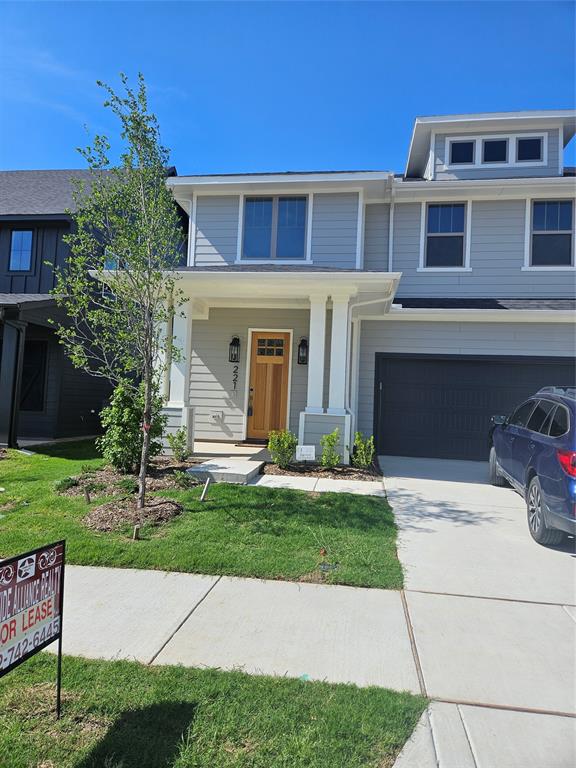 a front view of a house with a garden and yard
