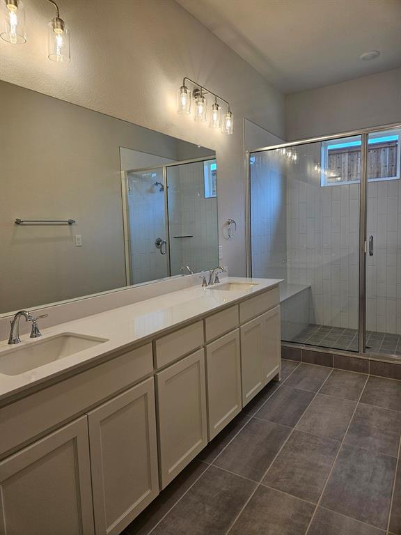 221 Chestnut Street Celina, TX 75009 - Photo 16 of 23 a spacious bathroom with a mirror sink and shower