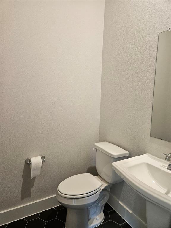 221 Chestnut Street Celina, TX 75009 - Photo 21 of 23 a white toilet sitting next to a white sink