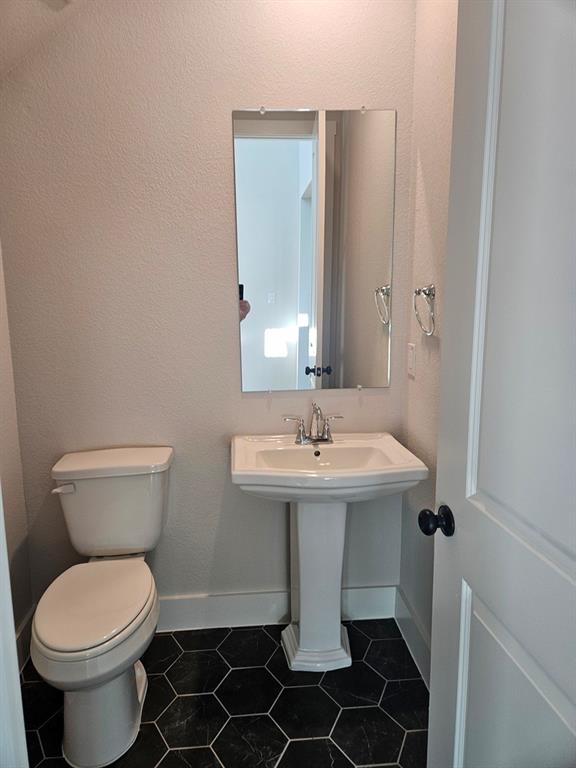221 Chestnut Street Celina, TX 75009 - Photo 4 of 23 a bathroom with a sink and a toilet