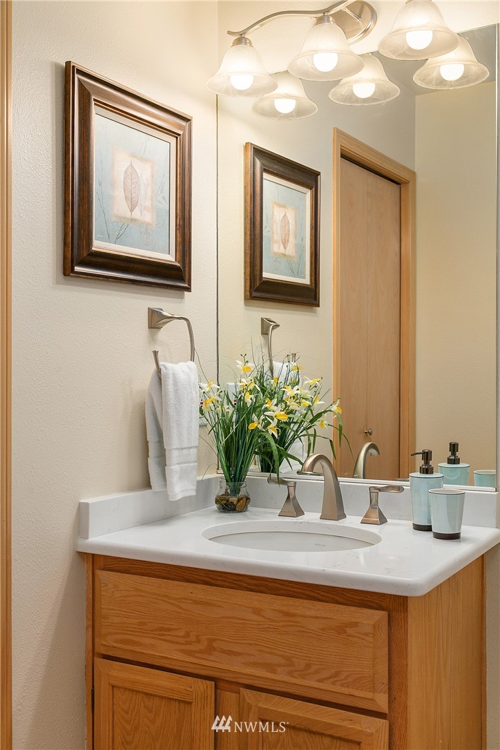 8515 Northeast 176th Street Bothell, WA 98011 - Photo 16 of 25 a bathroom with a sink a vanity and a mirror
