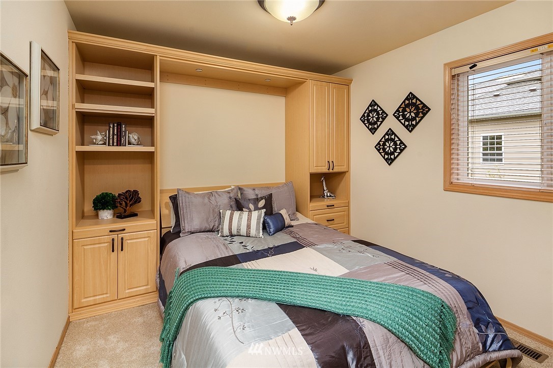 8515 Northeast 176th Street Bothell, WA 98011 - Photo 20 of 25 a bedroom with a bed and a window