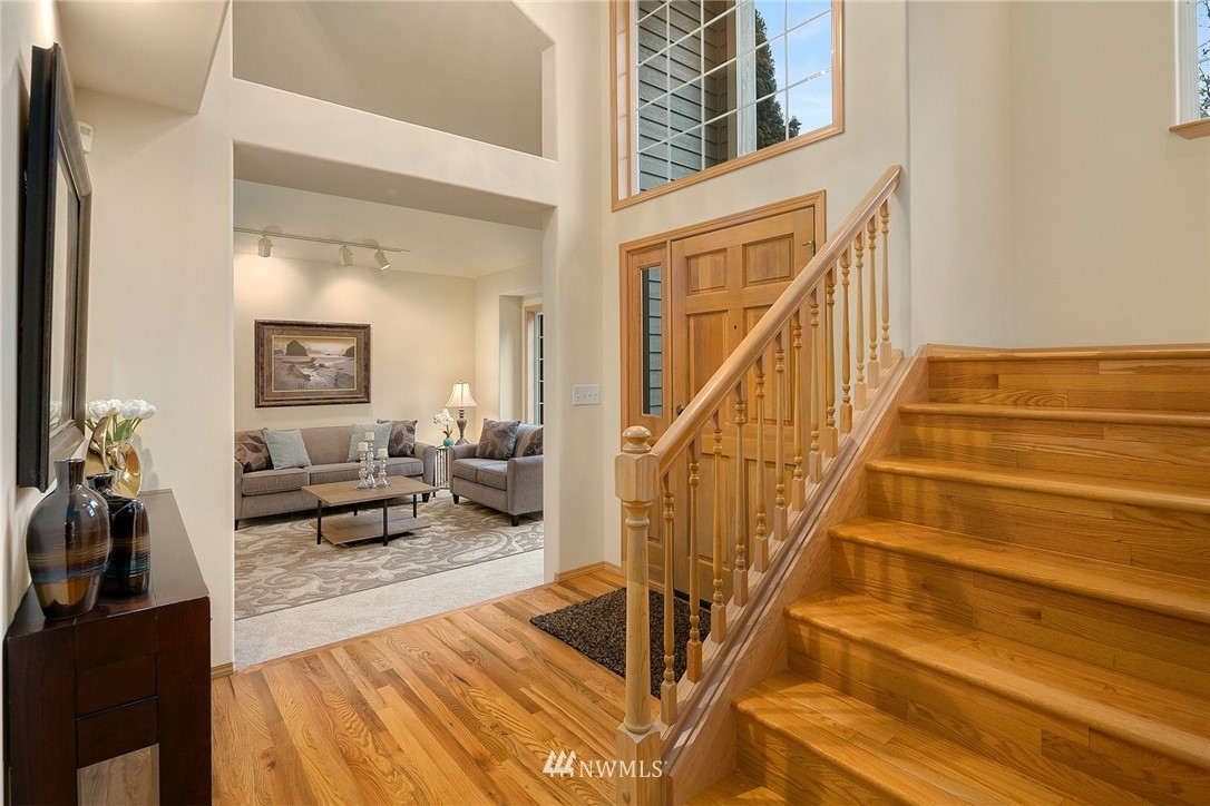 8515 Northeast 176th Street Bothell, WA 98011 - Photo 4 of 25 a view of an entryway with wooden floor and a livingroom view