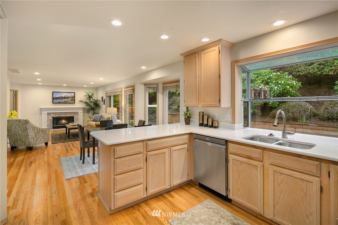 8515 Northeast 176th Street Bothell, WA 98011 - Photo 8 of 25 a kitchen with a sink windows and chairs