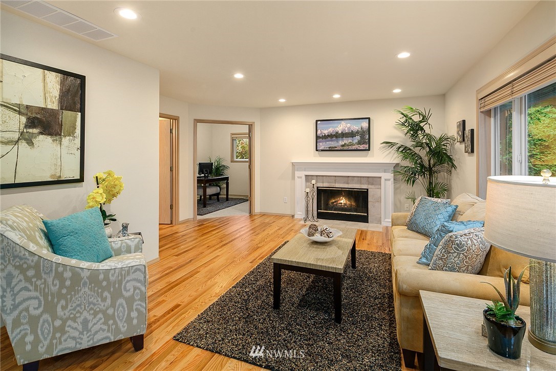 8515 Northeast 176th Street Bothell, WA 98011 - Photo 9 of 25 a living room with furniture and a fireplace