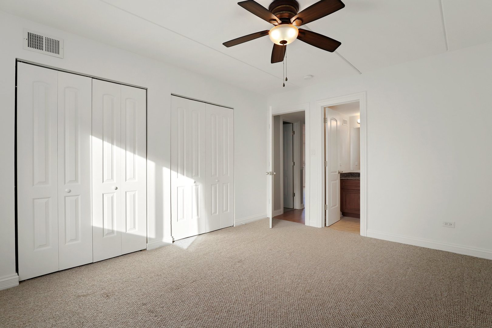 5509 Chateau Drive, Unit 1 Rolling Meadows, IL 60008 - Photo 12 of 16 an empty room with closet and a ceiling fan