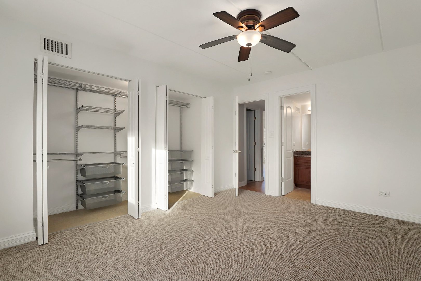 5509 Chateau Drive, Unit 1 Rolling Meadows, IL 60008 - Photo 13 of 16 a view of a room with closet and ceiling fan
