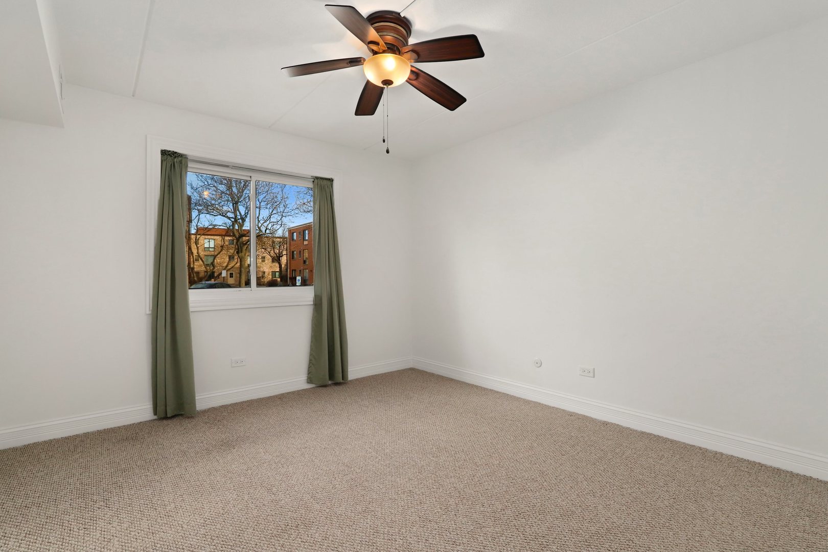 5509 Chateau Drive, Unit 1 Rolling Meadows, IL 60008 - Photo 15 of 16 an empty room with windows and fan