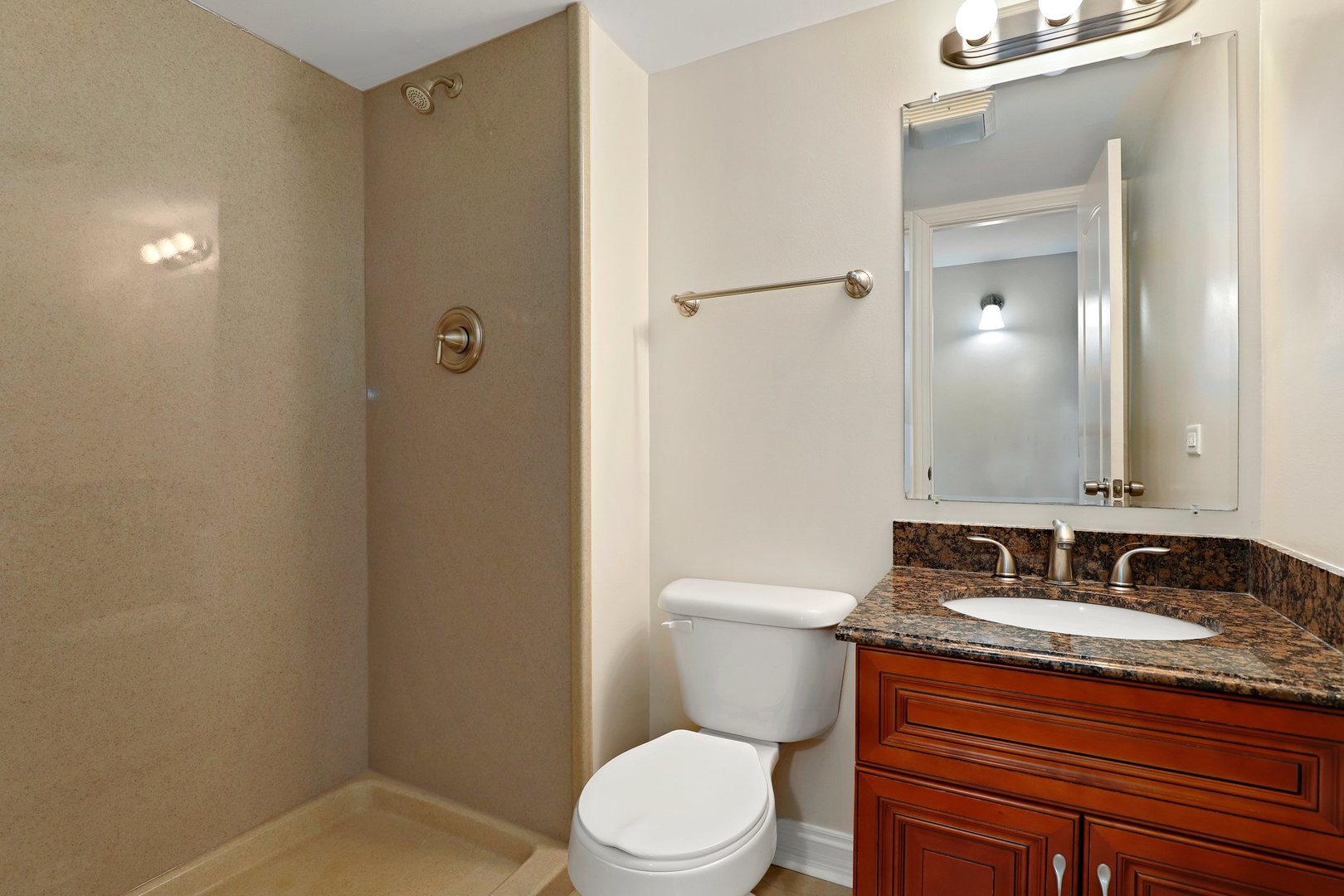 5509 Chateau Drive, Unit 1 Rolling Meadows, IL 60008 - Photo 16 of 16 a bathroom with a granite countertop sink toilet and shower
