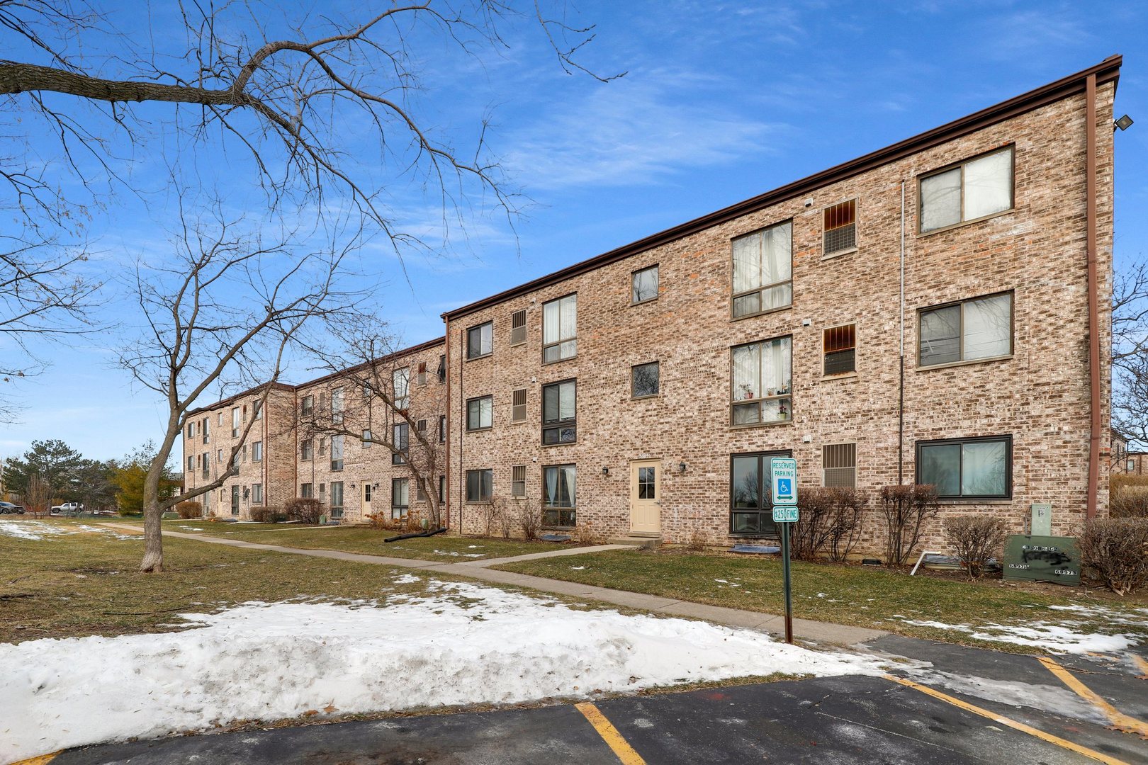 5509 Chateau Drive, Unit 1 Rolling Meadows, IL 60008 - Photo 2 of 16 a large building with a street sign on the side of it