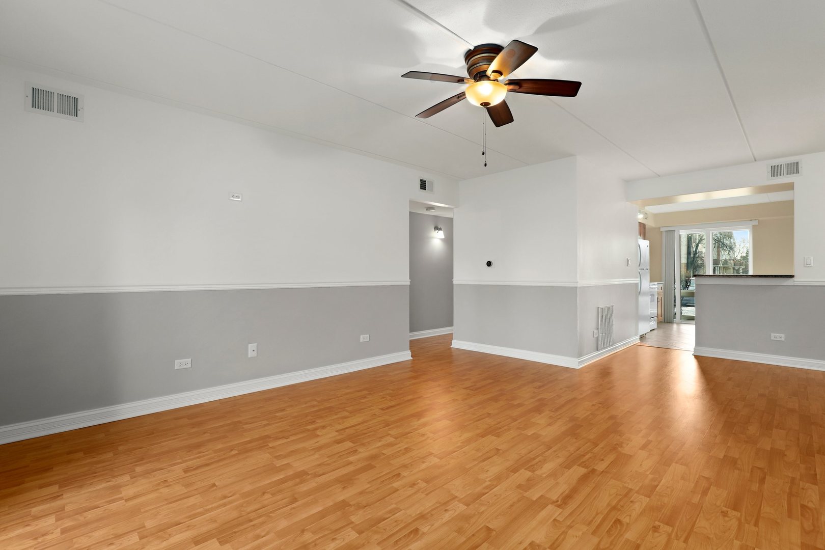 5509 Chateau Drive, Unit 1 Rolling Meadows, IL 60008 - Photo 5 of 16 wooden floor in an empty room with a window