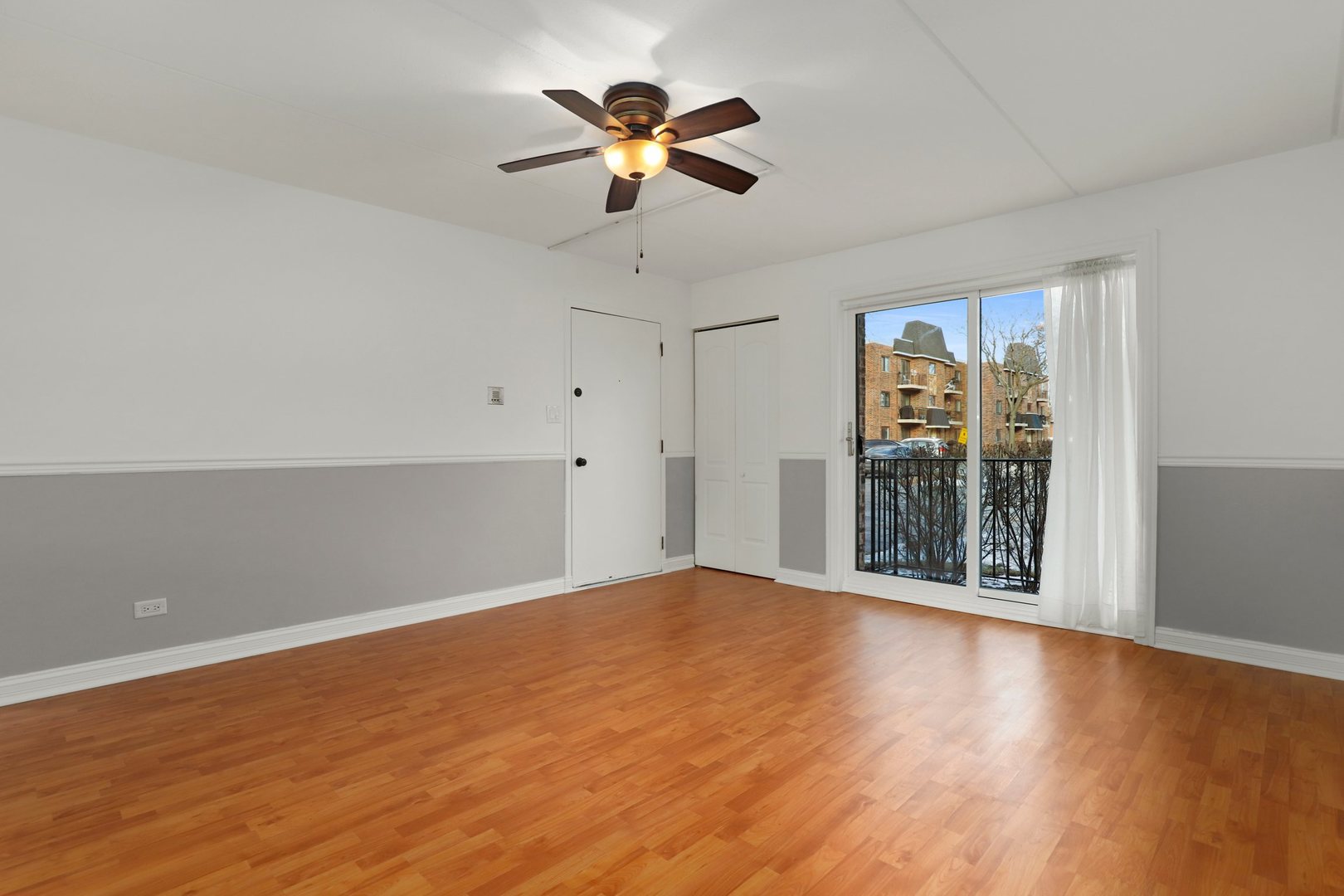 5509 Chateau Drive, Unit 1 Rolling Meadows, IL 60008 - Photo 6 of 16 wooden floor in an empty room with a window