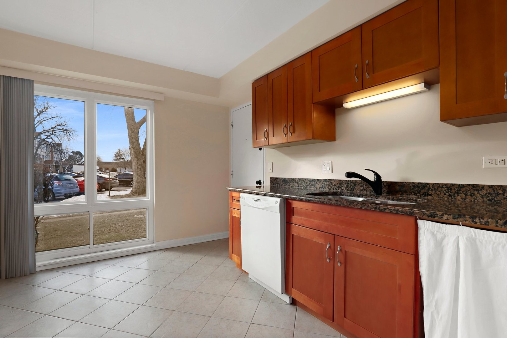 5509 Chateau Drive, Unit 1 Rolling Meadows, IL 60008 - Photo 10 of 16 a kitchen with stainless steel appliances granite countertop a sink stove and refrigerator