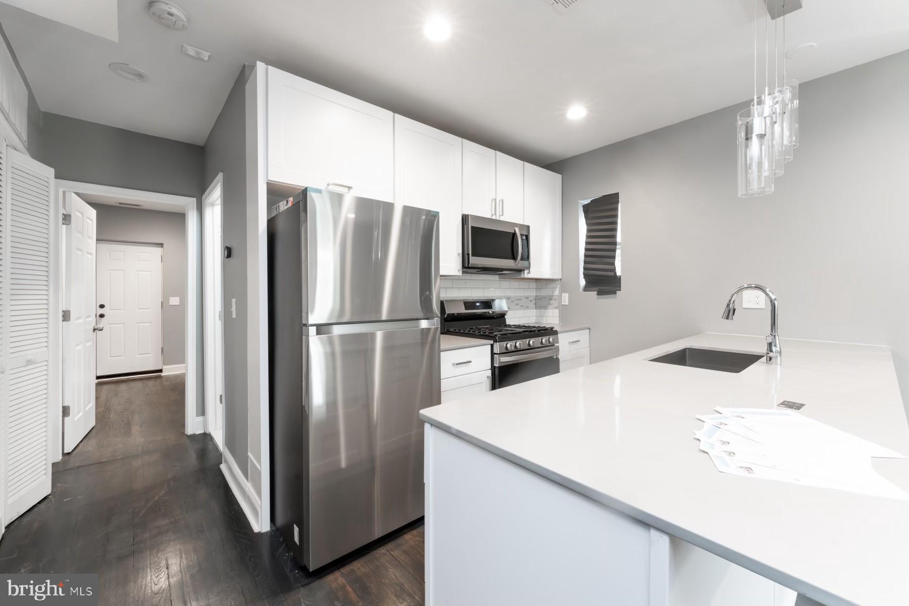 1606 29th Street Southeast Washington, DC 20020 - Photo 5 of 12 a kitchen with stainless steel appliances a refrigerator microwave and sink