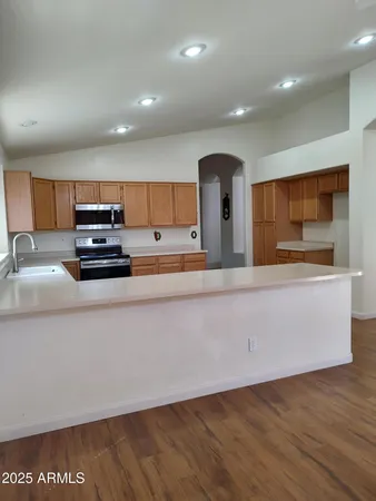 a kitchen with stainless steel appliances a refrigerator sink and microwave
