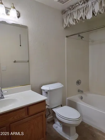 a bathroom with a sink a toilet and bathtub
