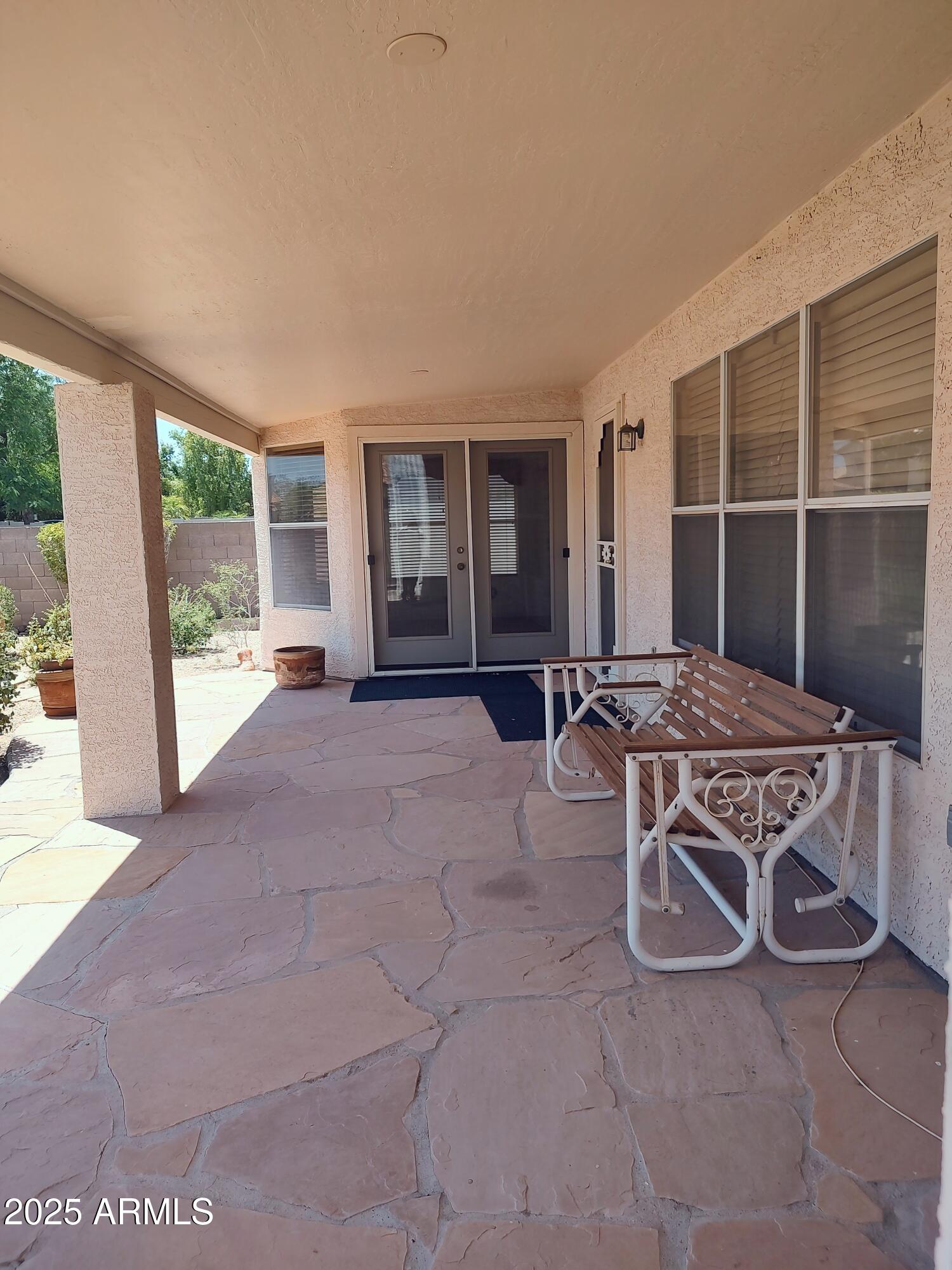 1365 West Courtney Lane Tempe, AZ 85284 - Photo 23 of 24 a living room with furniture a floor to ceiling window and potted plants