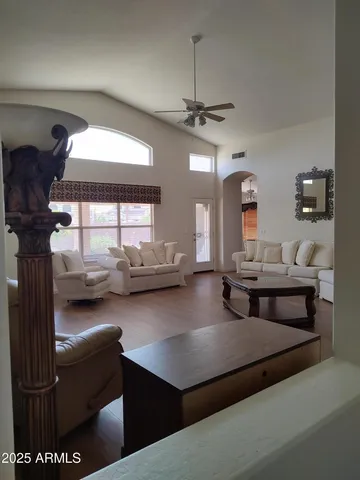 a living room with furniture and a chandelier