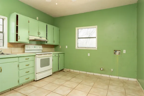 a kitchen with cabinets a sink and a window