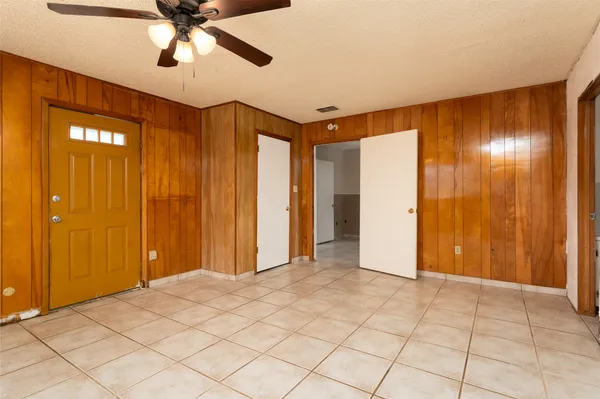 a view of a room with a chandelier fan and closet