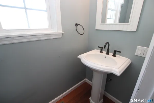 a bathroom with a sink a mirror and a window