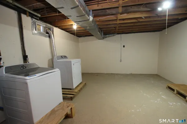 a view of storage and utility room with washer and dryer