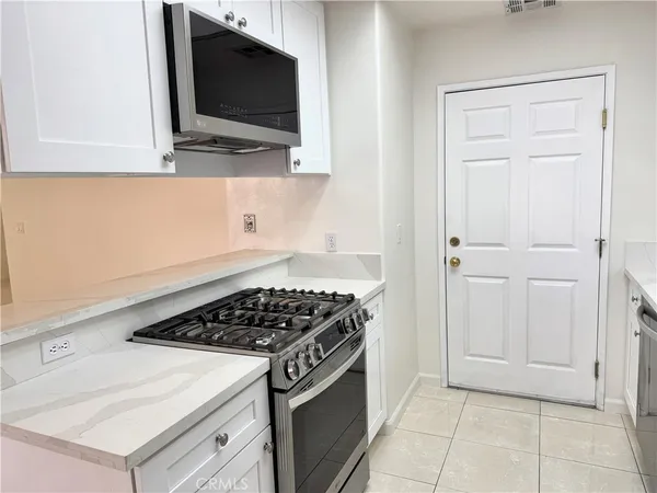 a kitchen with a stove and a microwave