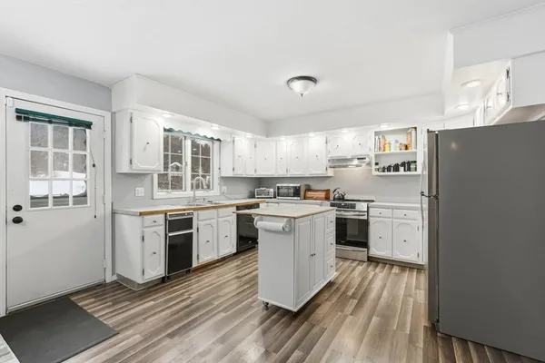 a kitchen with a refrigerator stove and sink